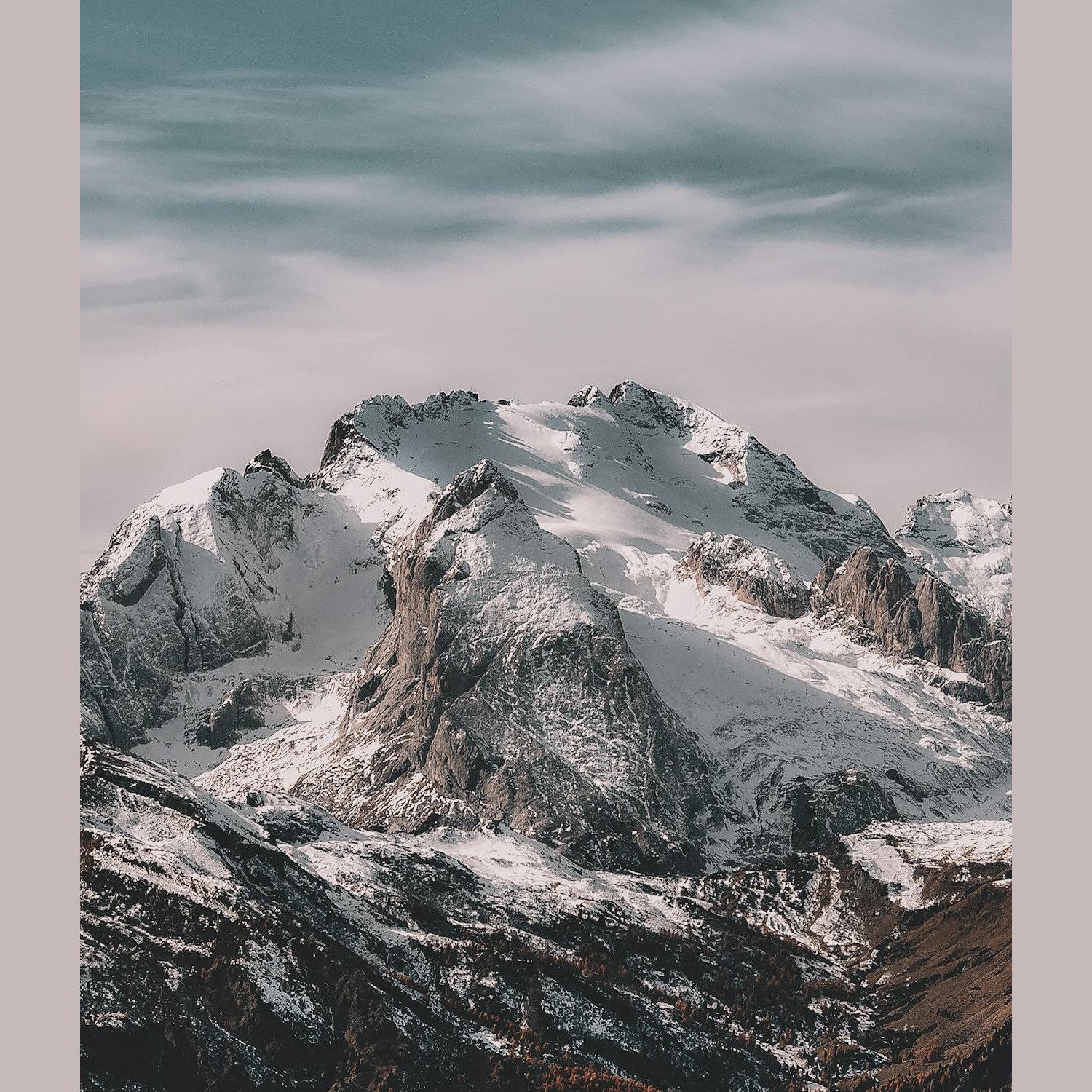 Snowy mountain peaks with cloudy sky