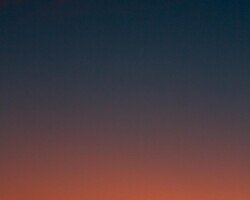 Crescent moon and fiery orange sunset horizon